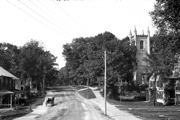 View down Center Street featuring the belfry of an Episcopal Church on the right.