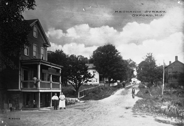View of a boarding house and other homes on Mechanic Street, a country lane.