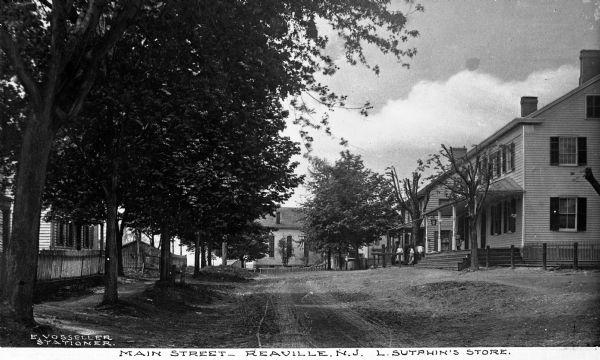 View down Main Street featuring family residences and L. Sutphin's Store.  Published by E. Vosseller, Stationer.