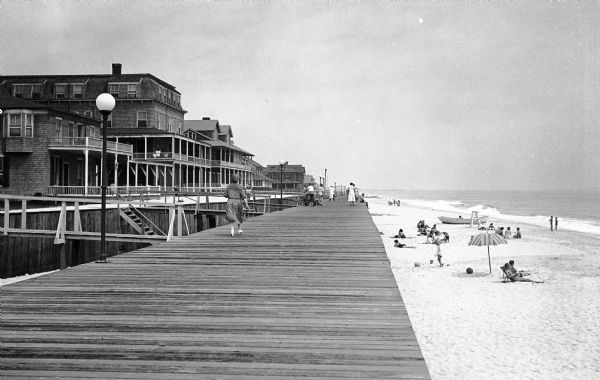 View of residences on a boardwalk facing the beach.