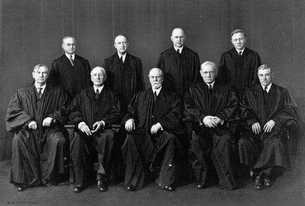 Formal group portrait of the United States Supreme Court with Chief Justice Charles Evans Hughes (1862-1948) seated in the middle of the front row.