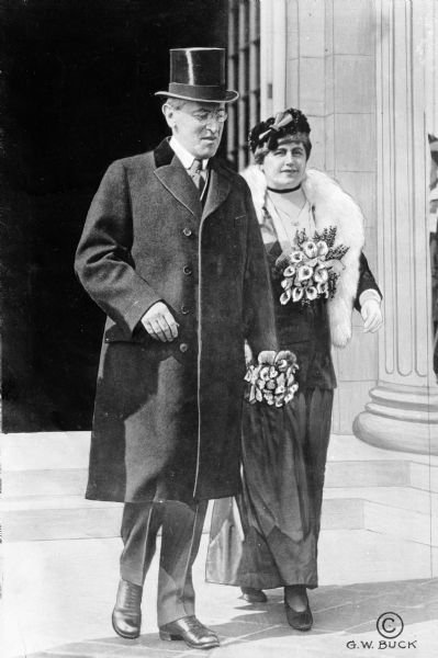 News photograph of Woodrow Wilson (1856-1924) and his second wife, Edith Wilson (1872-1961), walking.
