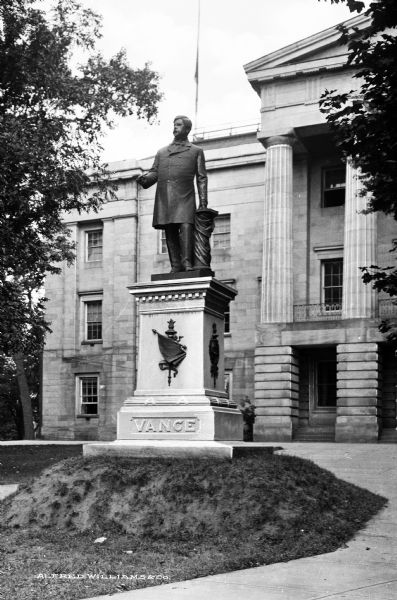 Statue of Zebulon Baird Vance (1830-1894), United States Senator. The statue stands before the Wisconsin State Capitol building, completed in 1840.  Published by Alfred Williams & Co.