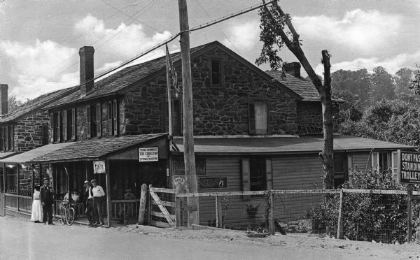 Exterior of Bonner's Store.  Men and women stand on the store's porch.