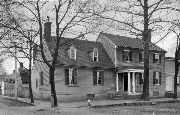 View of the modest home of Mary Washington (1708-1789), purchased by George Washington in 1772.  The two-story residence features a front porch and is situated on the corner of a residential block.