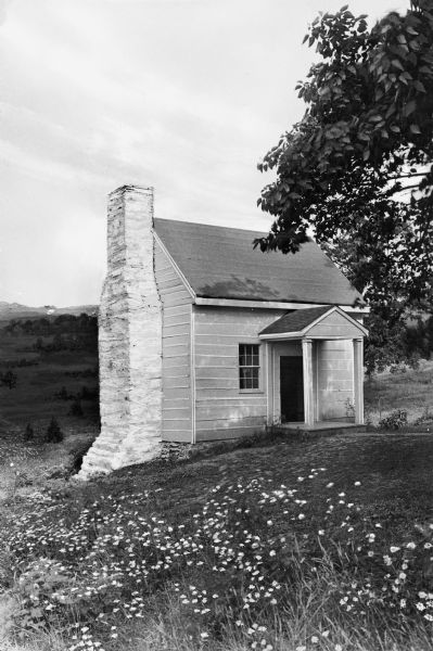 Exterior of Ash Lawn, the official residence of James Monroe during the years 1799-1823. View features the overseer's cottage with an old stone chimney.