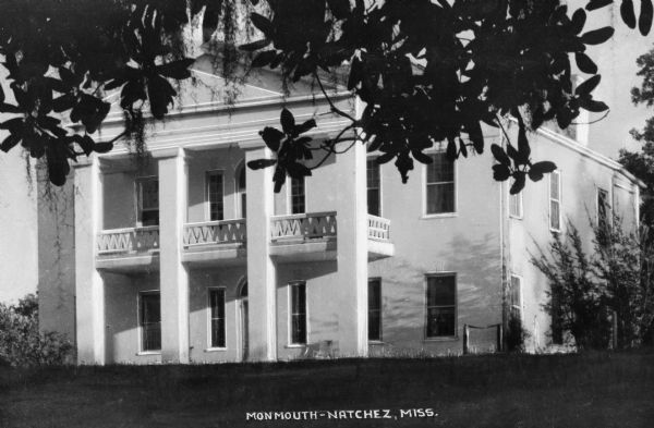 Exterior of Monmouth, built in 1818 in the Greek Revival style.  The residence features a colonnaded entrance and front balcony.