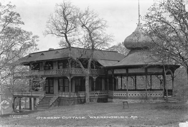 Exterior of Stewart Cottage, a home with an attached gazebo. Published by C.H. Harrison.
