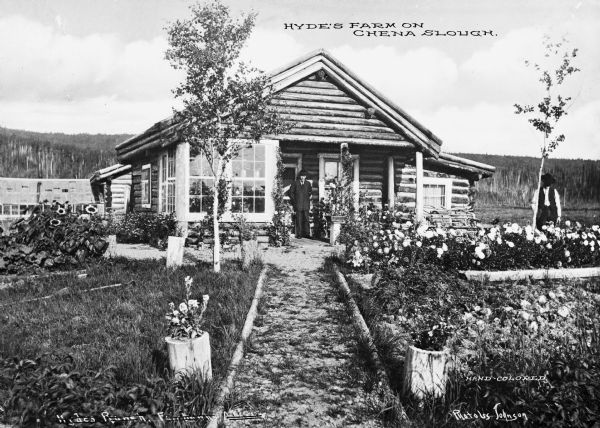 Two men stand outside Hyde's farmhouse on Chena Slough.