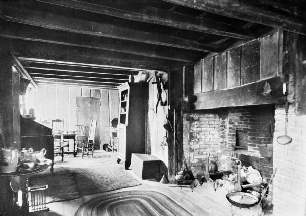 Interior view of the Alden House, built in 1653.  The kitchen and dining area feature a large fireplace and a beamed ceiling.