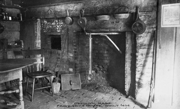 Interior of Fairbanks House, built in 1636.  The kitchen features a large fireplace and cooking utensils.