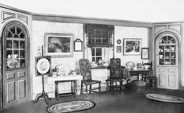 Interior of Judson House, built by Captain David Judson in 1750. The dining room features highly decorated dishware and closets in the corners of the room.