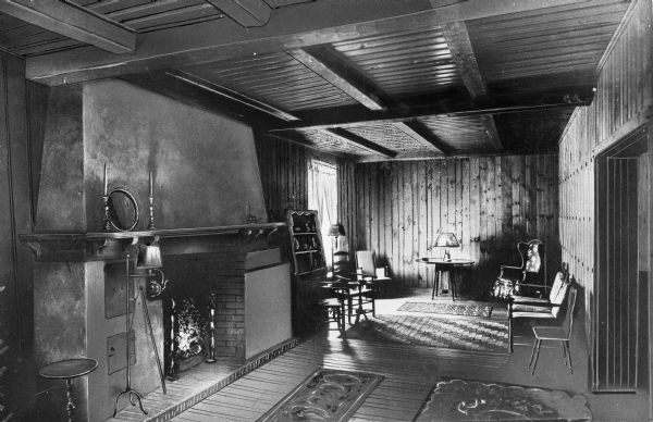 Interior view of 'The Nook' at Norwich Inn, built in 1929.  The space features an open fireplace, a beamed ceiling, and a parlor.