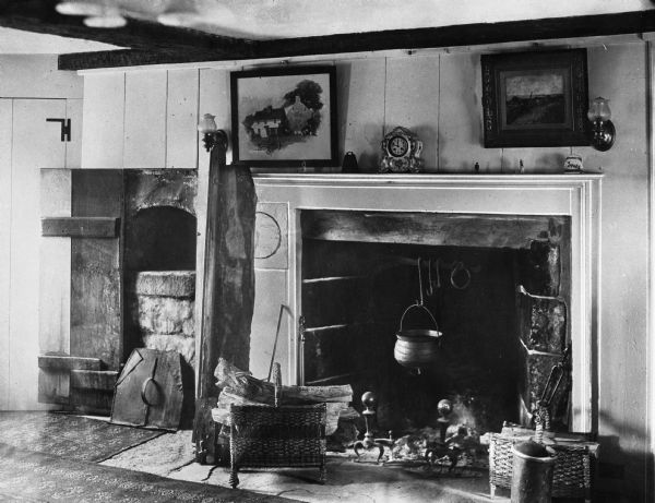 Interior of the Pardee-Morris House, built around 1680 and rebuilt in 1780 after a British raid.  The room features a large fireplace with a clock and paintings above.