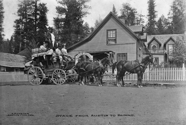 Side view of a stagecoach traveling from Austin to Burns, Oregon. The coach stands in front of Austin House.
