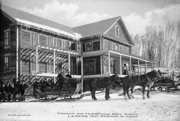 View of a horse-drawn sleigh used as a mail and passenger stage between Tanana and Fairbanks. Writing on sleigh reads: "Tanana-Fairbanks Stage" Caption reads: "Tanana And Fairbanks Mail Stage, Leaving Hot Springs, Alaska."