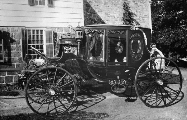 View of an elegant stagecoach outside the Pardee-Morris House, built around 1680 and rebuilt in 1780 after a British raid.