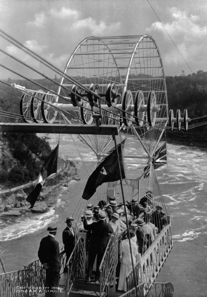 Passengers aboard a cable car prepare for their trip over Niagara Falls.