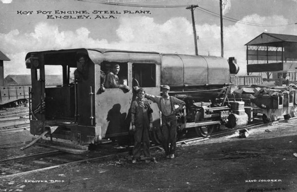 View of a work engine and crew at a steel mill. Published by Arbiter Bros.