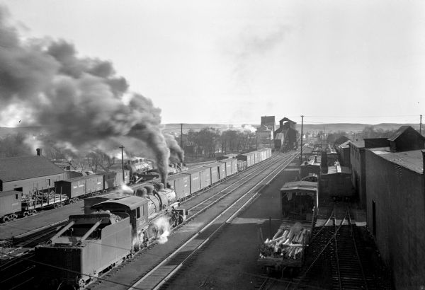 Elevated view of rows of railroad cars can be seen lined up on the tracks outside Minot Flour Mill Company, founded in 1903.