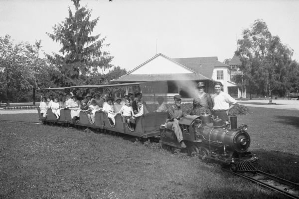 View of a miniature train with children and their parents as passengers at Springbank Park, founded in the late nineteenth century.
