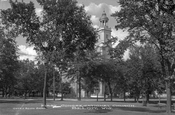 View across lawn of First Congregational Church. The view is perhaps taken from a park, which has trees and benches in the foreground. Caption reads: "First Congregational Church, Beloit, Wis."