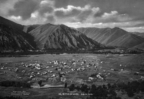 Elevated view of the city in a valley. Caption reads: "Ketchum, Idaho."