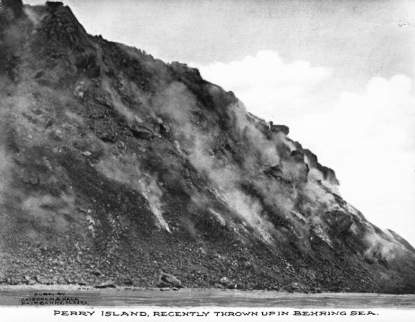 A view of Perry Island, a recent volcanic island. Caption reads: "Perry Island, recently thrown up in Behring Sea."