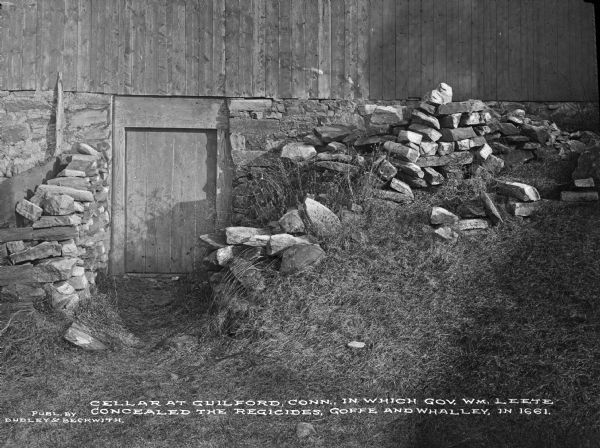 A view of the cellar door belonging to Gov. Wm. Leete, where the sympathetic Puritans concealed the regicide judges Whalley and Goffe in 1661. Caption reads: "Cellar at Guilford, Conn., in which Gov. Wm. Leete concealed the regicides, Goffe and Whalley, in 1661."
