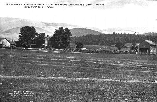 View across field toward General Jackson's old headquarters from the Civil War. A large farmhouse and other buildings are across the field. Caption reads: "General Jackson's Old Headquarters, Civil War, Elkton, VA."