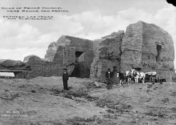 Two men, and three horses pulling a cart are in front of the ruins of Pecos Church. Caption reads: "Ruins of Pecos Church, near Pecos, New Mexico. Between Las Vegas and Albuquerque."