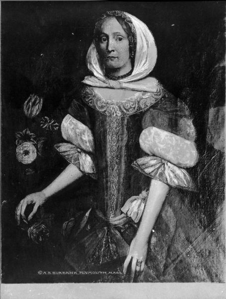A copy of the portrait painting of Elizabeth Paddy Winsley, who was of Plymouth, Massachusetts Colony ancestry. Elizabeth was marred to John Wensley, a very wealthy merchant. In the vase behind her, there are tulips, roses and carnations, none of which bloom at the same time of year. According to the Pilgrim Hall Museum, "Portraits from this era are rare. Elizabeth Paddy Wensley’s portrait is one of the finest."