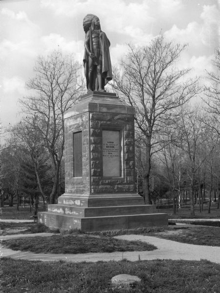 View of a statue of Chief Keokuk of the Sauk Indians located in Rand Park. The Keokuk chapter of the Daughters of the American Revolution was instrumental in erecting the statue. Chief Keokuk was an orator of extreme eloquence and noted for his policy of cooperation with the U.S. government. Text on the statue's base reads: "Sacred to the memory of Keokuck, distinguished Sac Chief Born at Rock Island in 1788, Died in April 1848."
