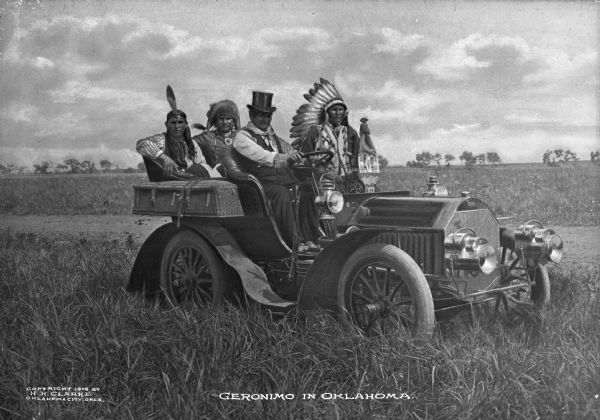 The Native American Chief Geronimo, prominent Native American leader and medicine man of the Chiricahua Apache, riding in an automobile with three other men. Caption reads: "Geronimo in Oklahoma."