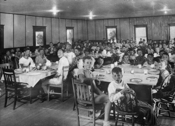 A view of the dining room filled with campers and counselors at Camp Wanasgrietta.