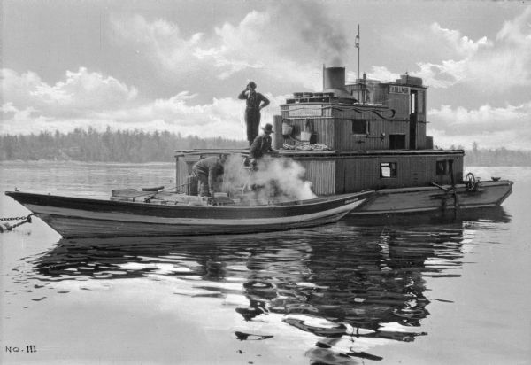 View of a flat bottom boat known as an "Alligator," which was used in "booming and towing" logs on rivers.
