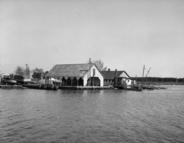 A boat landing and repair shop located on the edge of a lake.