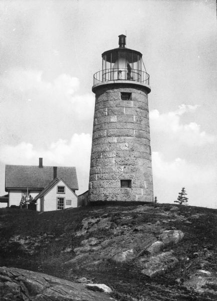 A view of the Monhegan Island granite lighthouse, built in 1850 and automated in 1959, with the keeper's house close by, which was originally erected in 1822.