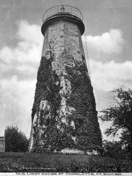 A view of the Charlotte-Genesee Lighthouse, constructed in 1822 on a hill just west of the Genesee River, covered in vines. This light was built in 1822 (not 1820, as it says on the photograph) to mark the entrance to the Port of Rochester.