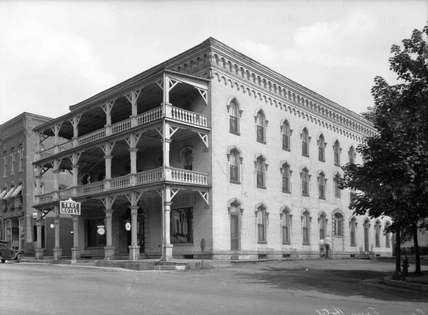 View across street toward the exterior of the three-storied Troy Hotel.