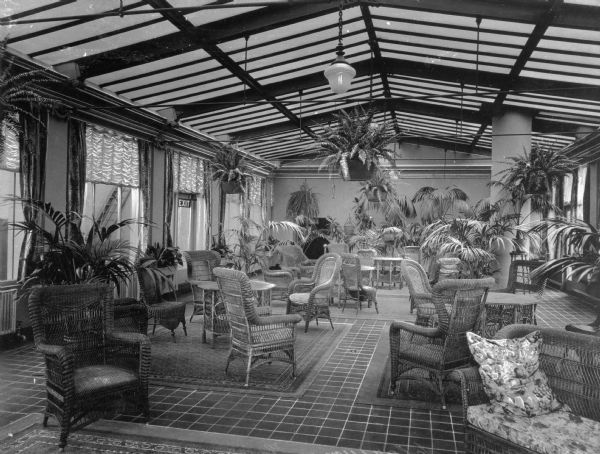 A view of the solarium at the Hotel Vendome. The solarium is arranged with plants and wicker chairs. Built in 1871 and massively expanded in 1881, the Vendome was a luxury hotel located in Boston's Back Bay, just north of Copley Square. During the 1960s, the Vendome suffered four small fires. The Hotel Vendome caught fire on June 17, 1972 resulting in the worst fire fighting tragedy in Boston history when 9 fire fighters were killed due to part of the building collapsing.