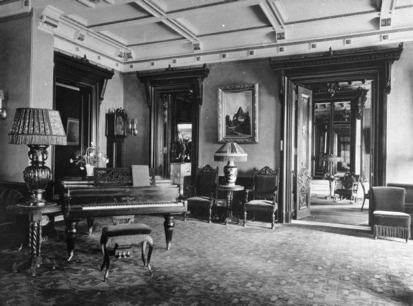 A view of the Hotel Vendome's music room. The room has a piano, tables, lamps and chairs. Built in 1871 and massively expanded in 1881, the Vendome was a luxury hotel located in Boston's Back Bay, just north of Copley Square. During the 1960s, the Vendome suffered four small fires. The Hotel Vendome caught fire on June 17, 1972 resulting in the worst fire fighting tragedy in Boston history when 9 fire fighters were killed due to part of the building collapsing.