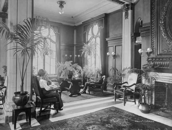 A view of several people relaxing in the foyer of the Elton Hotel. The Elton was considered one of New England's most elegant hotels until the 1960s, when it became the Roger Smith Hotel. It then became an assisted living facility. Notably, President John F. Kennedy made a campaign speech from the balcony of the hotel on Sunday, November 6, 1960.