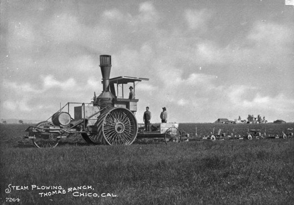A view of three men on a steam plow in a field. Caption reads: "Steam Plowing, Thomas Ranch, Chico, Cal."