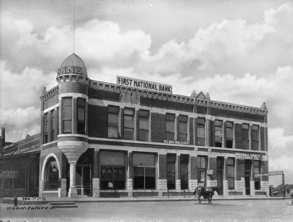 A view of the exterior of the First National Bank and surrounding buildings.