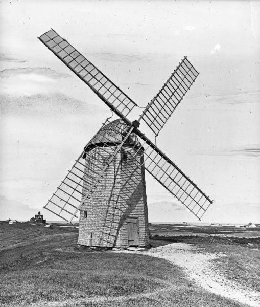 View toward a windmill, possibly the related to the Littlefield Mill (built in 1877). Dwellings are in the background.