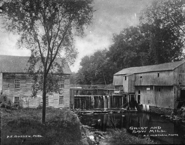 A view of a grist mill and sawmill with a waterfall between them. Caption reads: "Grist and Saw Mill."
