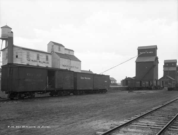Loading Great Northern Railroad cars at the Rugby Milling Co.