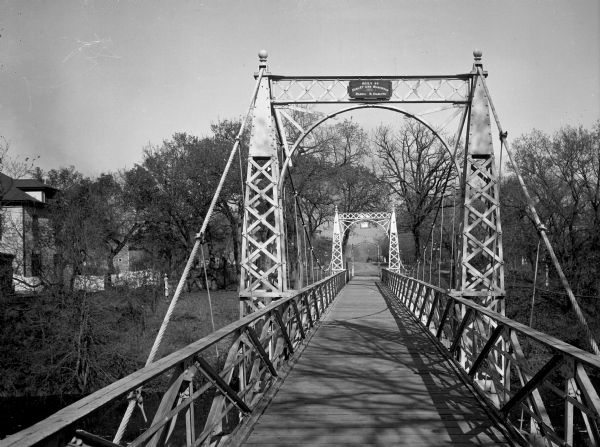 A view of a pedestrian suspension bridge over the Sheyenne River, built by Dibley and Robinson Bridge Company in 1801.