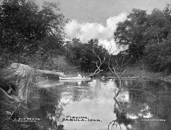 A small cove featuring a woman fishing from boat. Caption reads: "Fishing, Subula, Iowa."